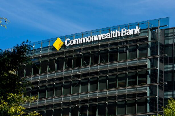 Commonwealth Bank office building with modern glass exterior and company logo displayed on the top facade, photographed during the day.