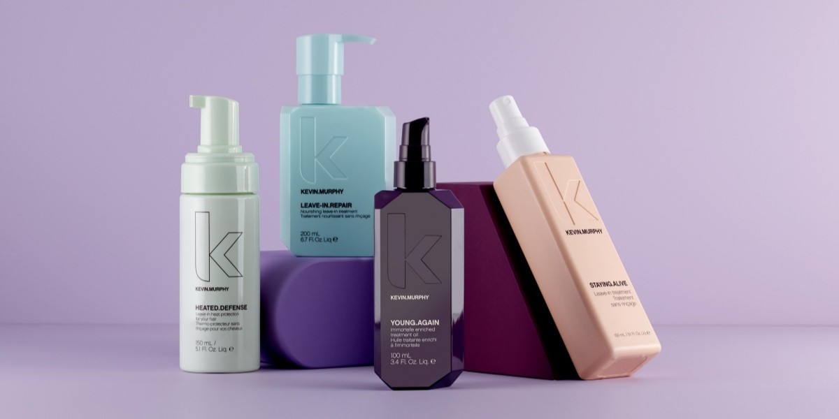 Kevin Murphy haircare products displayed on purple geometric blocks against a soft lavender background.