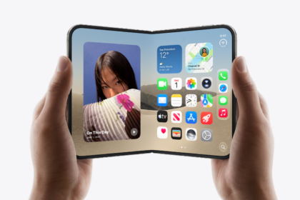 Hands holding an open foldable smartphone displaying apps, widgets and photos on its large screen.